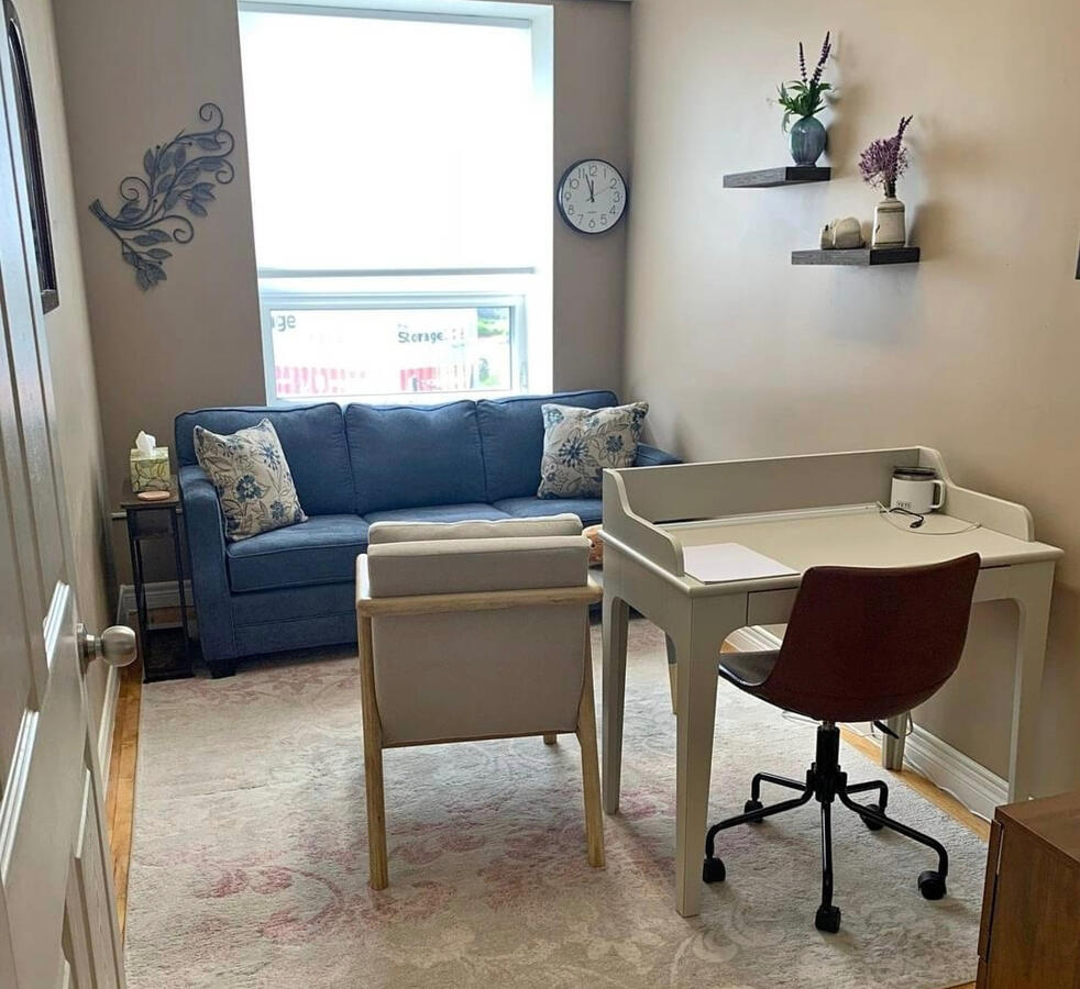 Therapy office with couch and armchair and natural light
